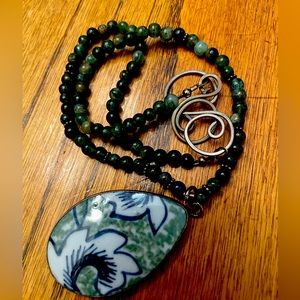 Handcrafted - pendant set in the middle of green 3/16” semi precious stones